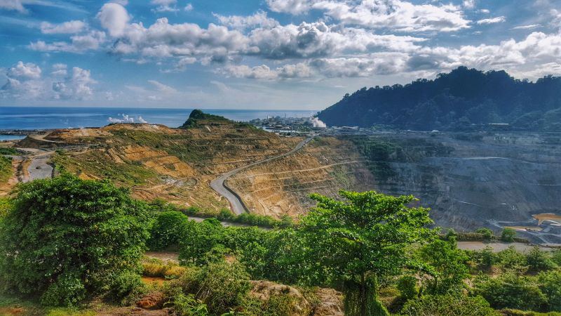 Open-pit mine on Lihir Island, Papua New Guinea, with the ocean behind